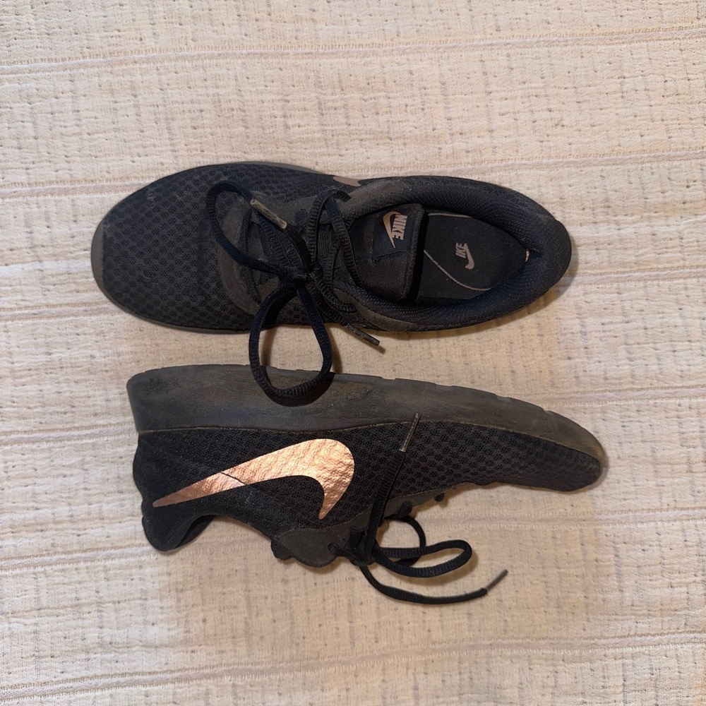 Nike black and rose gold running shoes